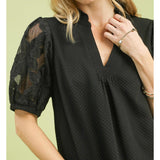 Close‑up of model wearing the Black Flower Lace Sleeve Blouse, focusing on the floral lace sleeve texture 