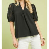 Woman wearing the Black Flower Lace Sleeve Blouse, front view showing the floral lace sleeves and cream bodice