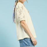 Woman wearing the Cream Flower Lace Sleeve Blouse, side angle highlighting the lace sleeve 