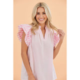 Model wearing the pink and white stripe flutter sleeve blouse, front view showing the soft flutter sleeves and classic striped pattern.