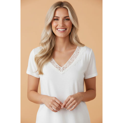 Front view of a model wearing the white lace V‑neck tee, showing the soft lace accents and flattering neckline in a relaxed, everyday fit.