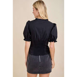 Model highlighting the textured back smocking detail and soft feminine fit.