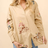 Light brown long sleeve button up shirt with colorful embroidered cowgirl Motifs. 