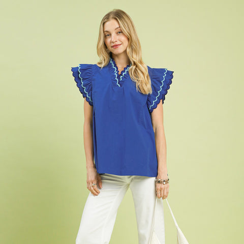 Model wearing a solid ocean blue ruffle scalloped sleeve top, front view showing the scalloped trim, ruffle sleeves, and Western‑inspired feminine style.