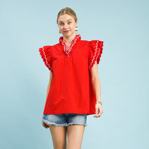 Model wearing a solid red scallop trim ruffle sleeve top, front view showing the scalloped neckline and soft ruffle sleeves