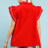 Back view of model wearing a solid red scallop trim ruffle sleeve top showing the clean back and easy, feminine fit.
