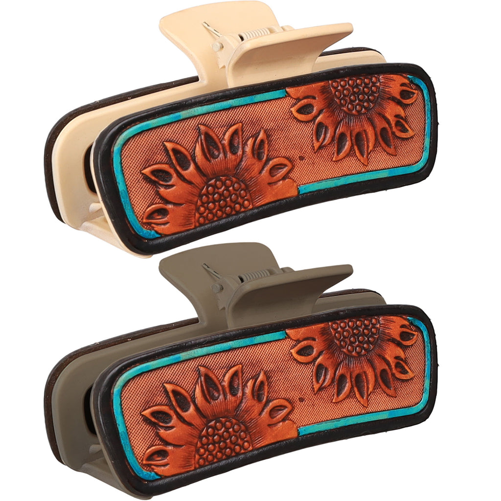 Close‑up of the sunflower tooled leather hair clip focusing on the detailed sunflower tooling and turquoise accents in both colors