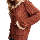 Side view of sweater, model has her hand in one of the front pockets. 