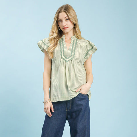 Model wearing a sage striped scalloped trim flutter sleeve top, front view showing the scalloped neckline and soft flutter sleeves.