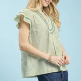 Side view of model wearing the sage striped scalloped trim flutter sleeve top highlighting the flutter sleeves and striped pattern.