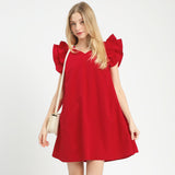 Model wearing a red seersucker ruffle sleeve shift dress, front view showing the textured fabric and soft ruffle sleeves.