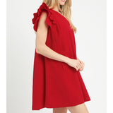 Side view of model in a red seersucker ruffle sleeve shift dress highlighting the ruffle sleeves side pocket and relaxed shift silhouette.