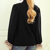 Back of the blouse, all black except for the leopard print on the end of the sleeves.