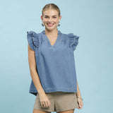 Model wearing a denim tiered ruffle sleeve top in a front view, showing the layered ruffle sleeves, soft denim fabric, and flattering relaxed silhouette.
