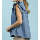 Side view of a model wearing a denim tiered ruffle sleeve top, highlighting the cascading ruffle layers and smooth denim drape.