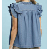 Back view of a model wearing a denim tiered ruffle sleeve top, showing the clean back design, soft denim texture, and flowy sleeve tiers.