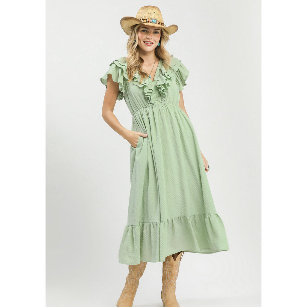 Model wearing a sage textured ruffle tiered midi dress, front view showing the ruffle sleeves, textured fabric, and flowy tiered skirt.