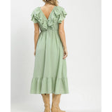 Back view of model wearing a sage textured ruffle tiered midi dress showing the relaxed fit and flowing tiered skirt.