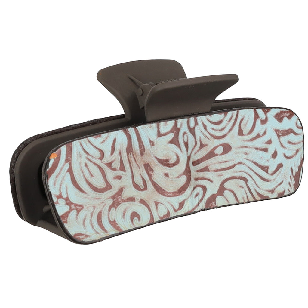 Angled view of the teal rose claw clip on a white background