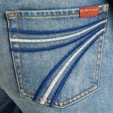 Close-up of the embroidered back pocket detail on 7 For All Mankind DOJO blue denim jeans.