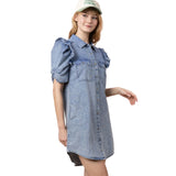 Model in the Indigo Denim Button Ruffle Sleeve Dress at an angle, displaying the button front, ruffle sleeves, and feminine movement.