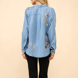 Back of the shirt, cowgirl designs are scattered and randomly placed.