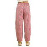 Back view of a model wearing red and white striped pants, showing the relaxed drape, elastic waistband, and soft striped fabric.