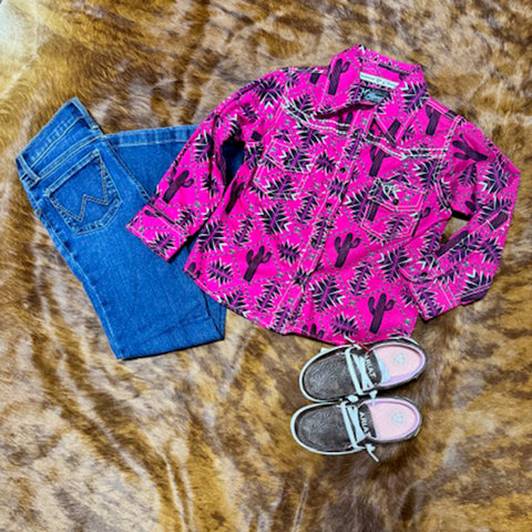 Bright Pink Pearl Snap With Graphics on it laying with jeans and shoes