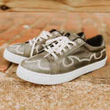 Tan leather tennis shoes with white boot stitch design on the sides and the toes, shoe has white laces and a white sole.