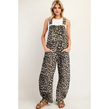 Woman wearing the Leopard Barrel Leg Jumpsuit, front view showing the relaxed fit, barrel‑leg silhouette, and bold leopard print