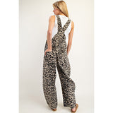 Woman wearing the Leopard Barrel Leg Jumpsuit, back view showing the loose, easygoing fit and full leopard pattern.