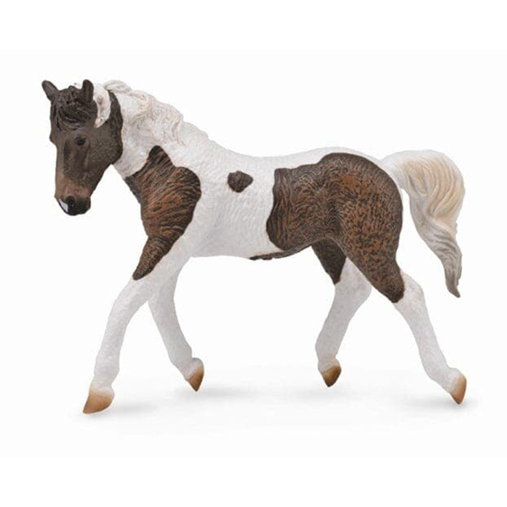 brown and white curly haired toy horse 