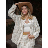 Model wearing a Cream Western Desert Graphic Jacket with bold desert artwork