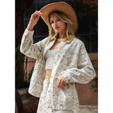Model wearing the Cream Western Desert Graphic Jacket with a close‑up view of the desert graphic