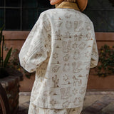 Model in a Cream Western Desert Graphic Jacket captured from the back