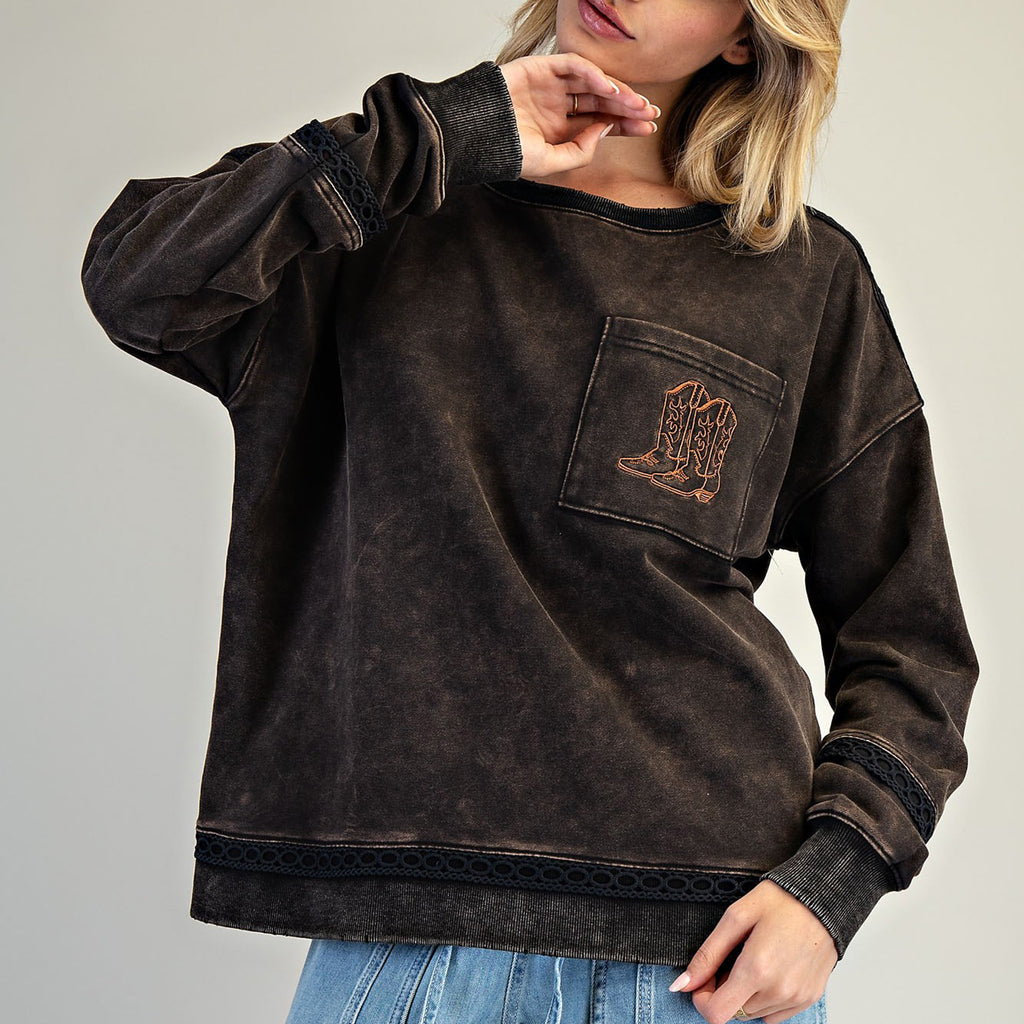 Black faded sweatshirt with a brown stitched boot on the chest pocket.