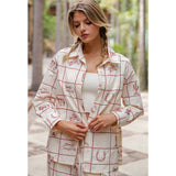 Model wearing a red grid Western button front shirt