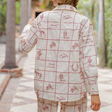 Back view of model wearing the red grid Western shirt highlighting embroidered accents and relaxed fit.