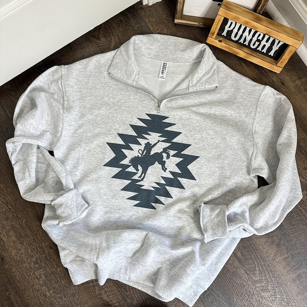 Ash grey quarter zip with navy blue Aztec design with a Bronc Rider in the middle. 