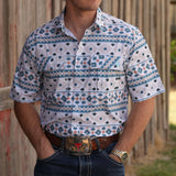 Full front side view of tan, white, and teal short sleeve shirt
