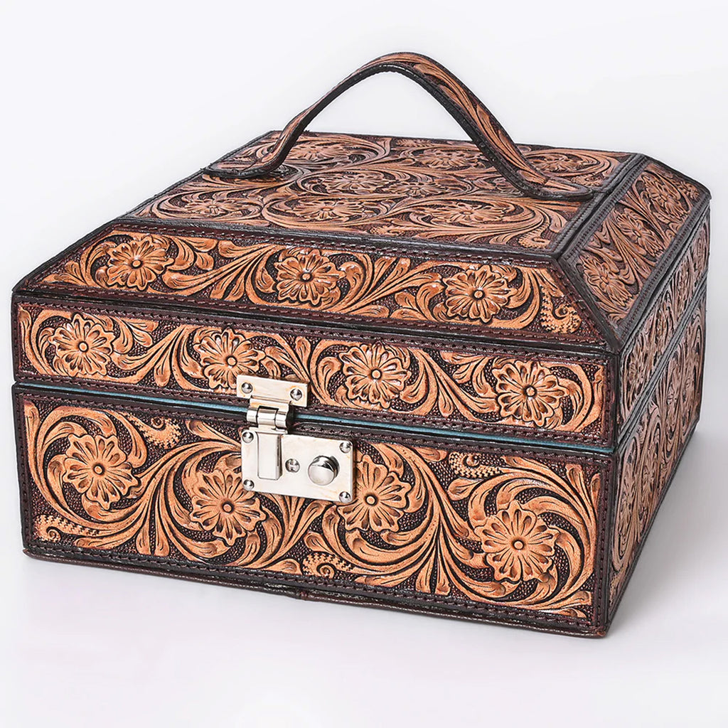 Square tooled leather jewelry case with handle on the top and silver lock on the front. 