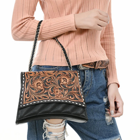 Style view of black and tooled floral purse with chain strap