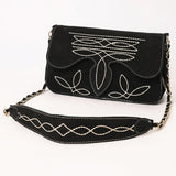 Black suede small clutch style purse with white boot stitch and chain strap and black and white suede strap.