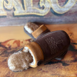 Side view of slipper, light brown fur lining on bottom of slipper 