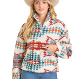 Cream sherpa quarter zip with blue, red, and orange Aztec print and two front zipper pockets.