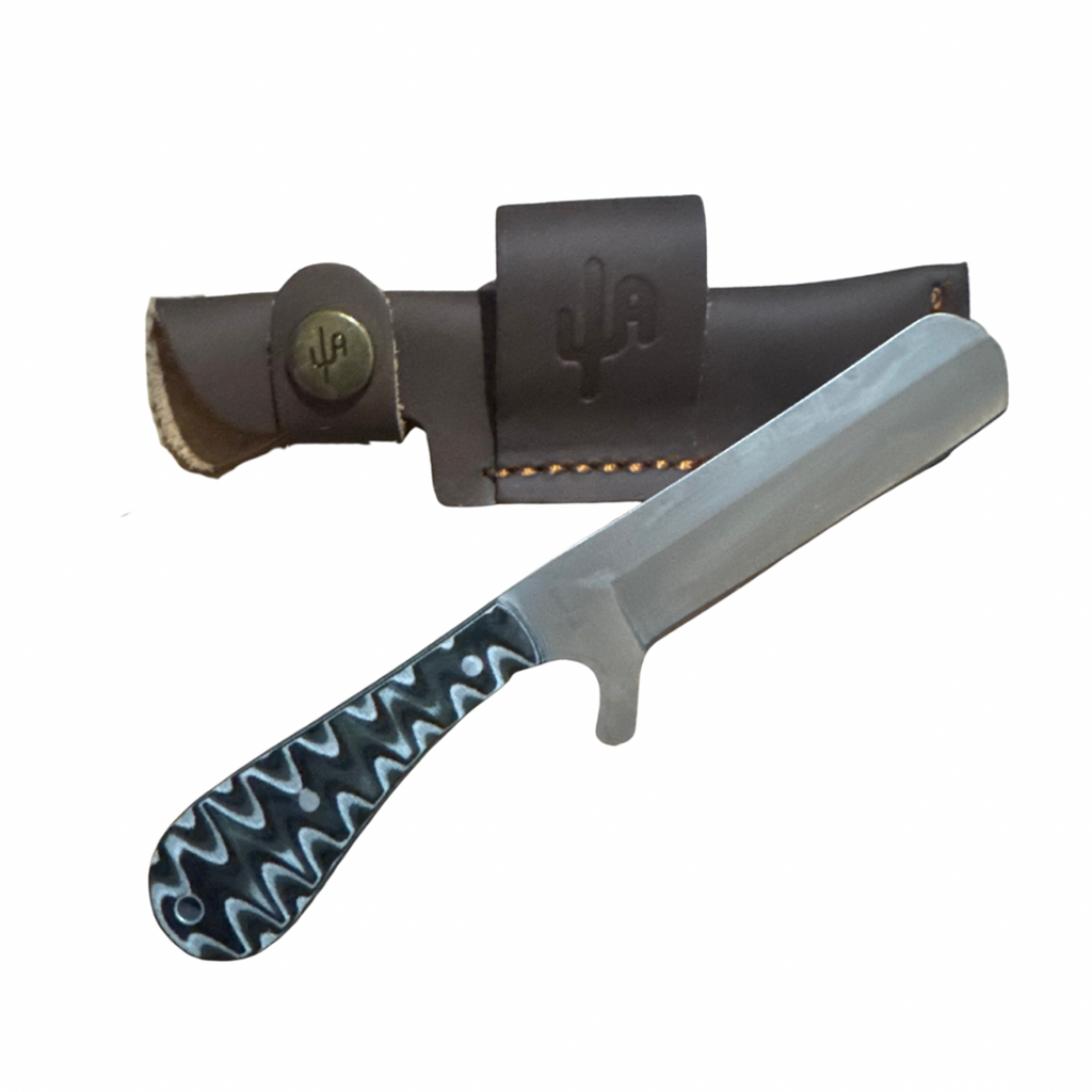 Knife with a black handle and silver blade, accompanied by a brown leather sheath on a white background.