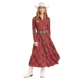 Model wearing a scarlet bandana‑print dress with a fitted bodice and flowy skirt, standing facing forward to show full silhouette.