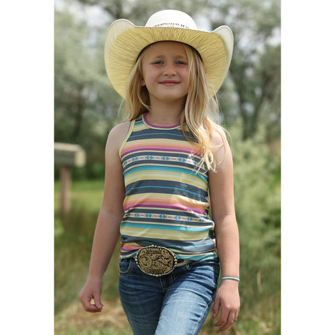 Girl wearing a multi serape striped tank top standing outside, showing bold Western stripes and sleeveless fit.