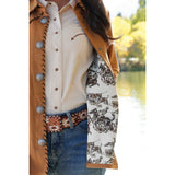 women's tan jacket with black whip stitch details and silver conchos with inside rodeo print fabric