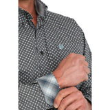 Close up of charcoal and blue diamond print shirt and blue plaid cuff.